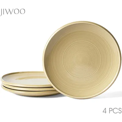A set of four plates stacked, with one plate in the foreground showing its textured surface.