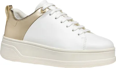 A studio shot of a white and gold sneaker.