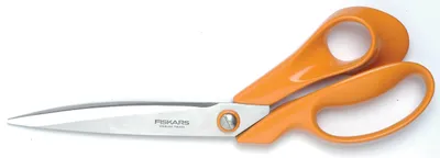 A pair of orange Fiskars scissors on a white background.