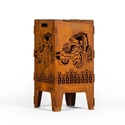 A rusty metal fire pit with tractor and wheat designs.
