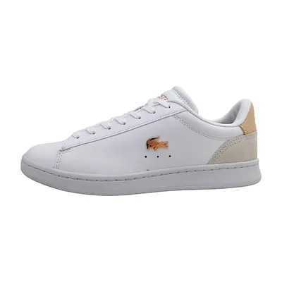 A white Lacoste sneaker with pink accents and a tan heel tab, shown from the side against a white background.