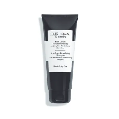 A black tube of shampoo with white text on a white background.