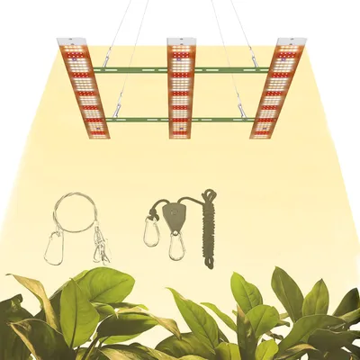 A grow light setup with plants in the foreground.
