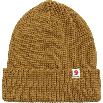 A close-up studio shot of a knitted beanie.
