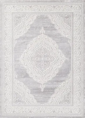 A top-down view of a rectangular rug with an intricate, embossed pattern.