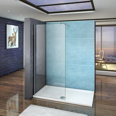 A modern bathroom with a glass shower enclosure against a blue brick wall, overlooking a scenic view.