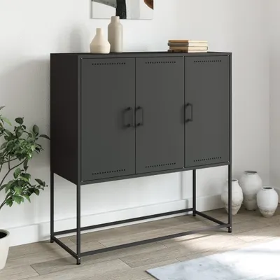 A black metal cabinet with three doors on a metal stand, placed in a room with a plant and vases.