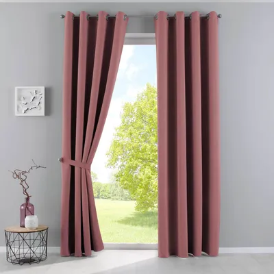 A room with a window covered by pink curtains, with a small table and vase on the left.