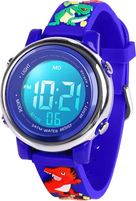 A close-up shot of a child's digital watch with a blue strap and a dinosaur design.