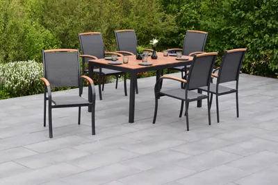 An outdoor dining set with a table and chairs on a patio.