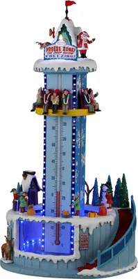 A festive Christmas-themed animated display featuring a tall tower with a thermometer, people on a ride, and Santa Claus at the top.