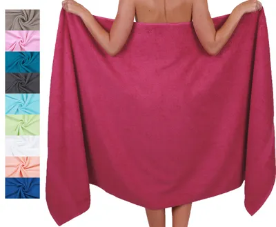 A person is holding a large, pink towel around their body, with a swatch of different colored towels visible on the left side of the image.