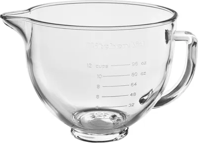 A close-up shot of a clear glass mixing bowl with measurement markings.