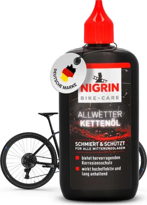 A bottle of NIGRIN Bike-Care chain oil is shown next to a bicycle.
