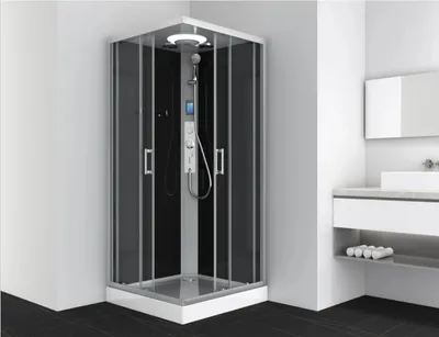 A modern bathroom with a corner shower cabin and a vanity with a sink.