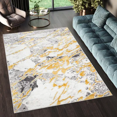 A modern living room with a rug, sofa, and armchair.