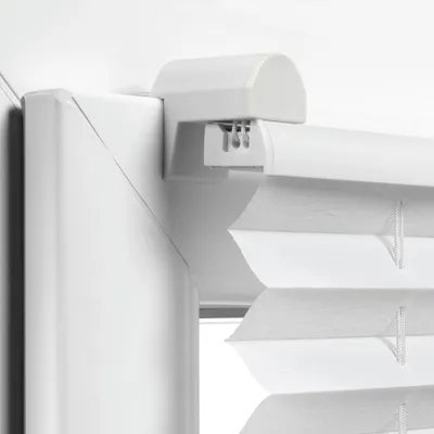 Close-up view of the top mounting bracket and pleated blind fabric.