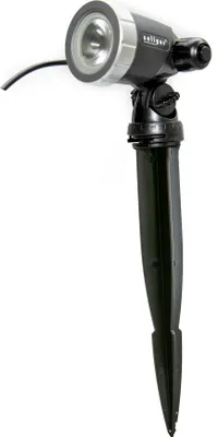 A black and silver outdoor spotlight with a stake.