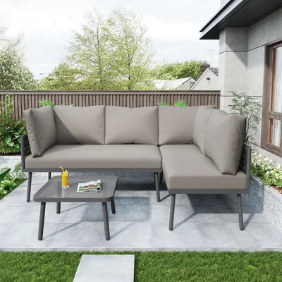 An outdoor patio scene with a sectional sofa and coffee table.