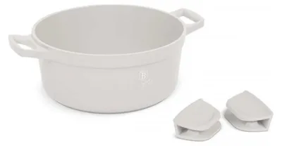 A white pot with two handles and two small white accessories are placed on a white background.