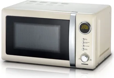 A cream-colored retro-style microwave oven shown from a slight angle with a reflective surface below.