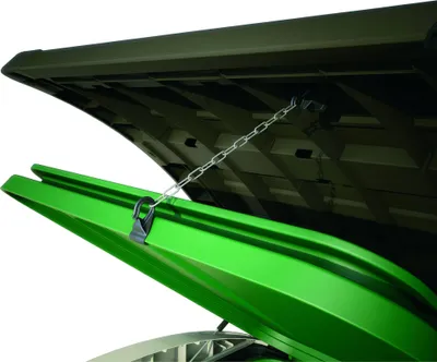 A close-up view of the inside of a dark green lid and a bright green bin, connected by a metal chain.