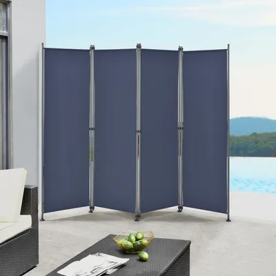 An outdoor privacy screen set up on a patio next to a pool.