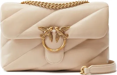 A beige leather handbag with gold hardware.