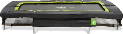 A rectangular trampoline with black padding and green accents, shown from a side-front angle on a white background.