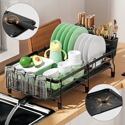 A dish drying rack filled with dishes, cups, and cutlery on a kitchen counter.