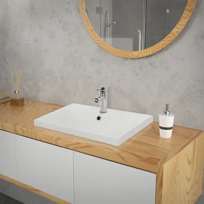 A modern bathroom vanity with a white ceramic sink and a wooden countertop.