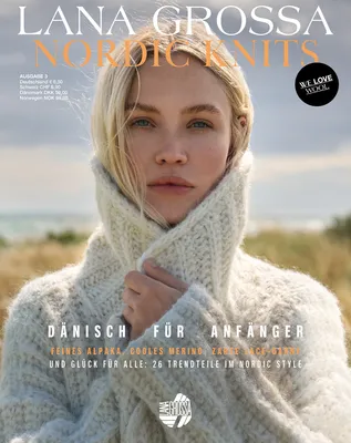 A woman wearing a knitted sweater, outdoors with a blurred background of grass and sky.