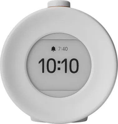 A white digital alarm clock with a screen displaying the time.