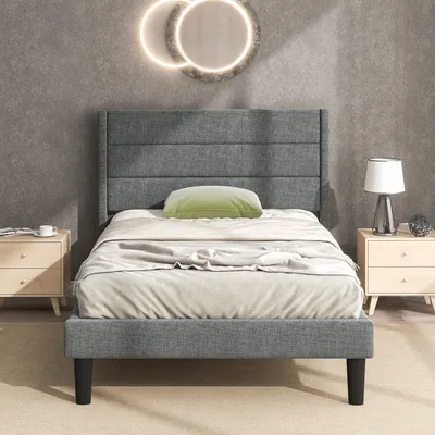 A bedroom scene with a bed, nightstands, and wall decor.