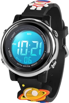 A close-up shot of a digital watch for children, featuring a black band with colorful cartoon characters and a blue digital display.