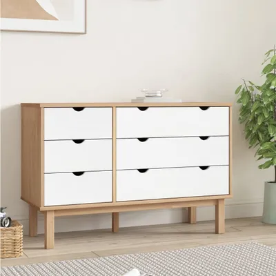 A dresser with six drawers in a room setting.