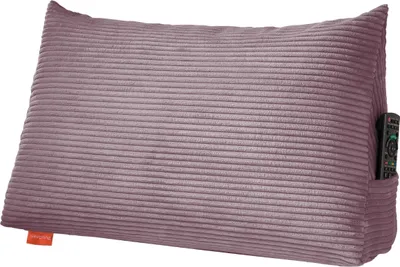 A corduroy pillow with a side pocket holding a remote control.
