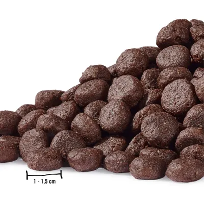 A pile of brown, round dog food kibble is shown against a white background.