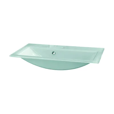 A mint green glass sink on a white background.