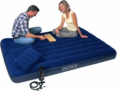 A couple playing a board game on a blue inflatable mattress.
