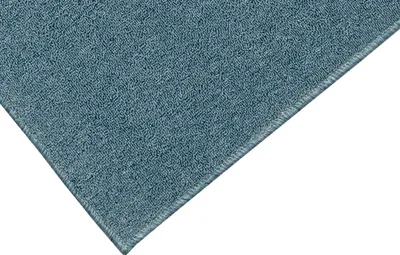 A close-up view of a blue carpet with a visible edge.