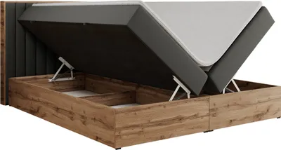 A bed with its storage compartment open, showing the mattress and the lifting mechanism.
