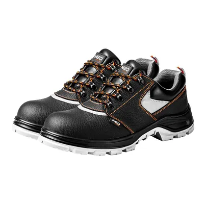A pair of black work shoes with orange laces and white accents, shown from a diagonal angle on a white background.