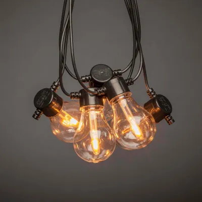 Produktbild von Konstsmide - LED Biergartenkette, klar, mit Dimmer, 10 klare Birnen / 20 bernsteinfarbene Dioden, 24 Außentrafo, schwarzes Kabel - 2391-800