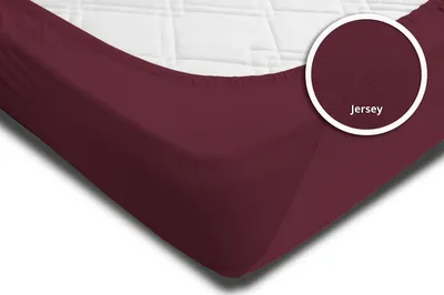 A close-up view of a burgundy fitted sheet on a mattress.