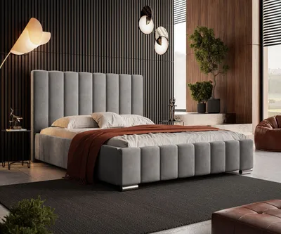 A modern bedroom with a large upholstered bed as the focal point.