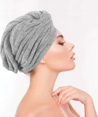 A woman wearing a gray hair towel turban.