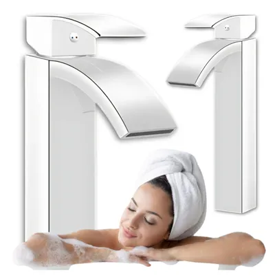 A woman in a towel is relaxing in a bath with a modern faucet in the foreground.