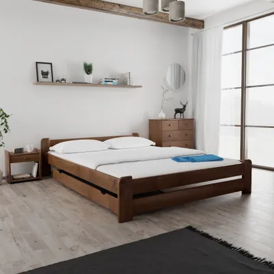 A bedroom scene with a wooden bed, nightstand, and dresser.