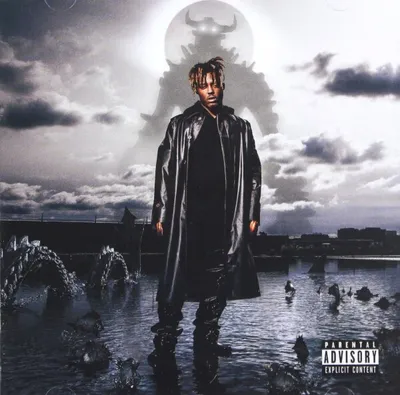 A person stands in a body of water with a large, shadowy figure in the background.